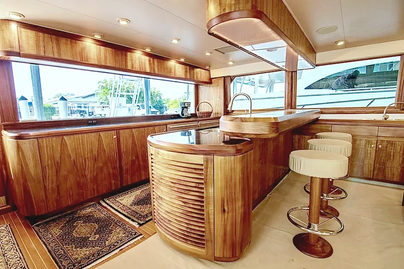 Redesigned aft galley with varnished joinery and bar stools